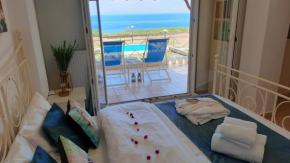 Blue Pastel-cliffside villa, shared pool, wild sandy beach nearby